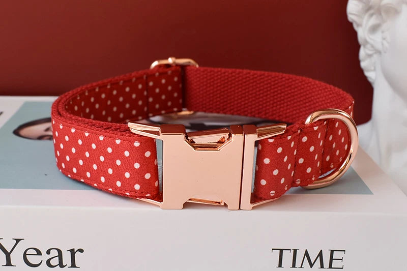 adjustable red bowtie dog collar with red polka dot webbing, rose gold buckle, and quick-release clasp for small dogs and cats