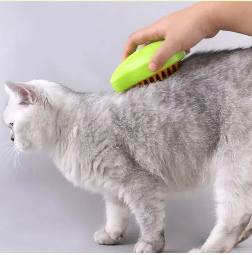 pet steam grooming brush used on a gray cat for shedding, massage, and coat detangling