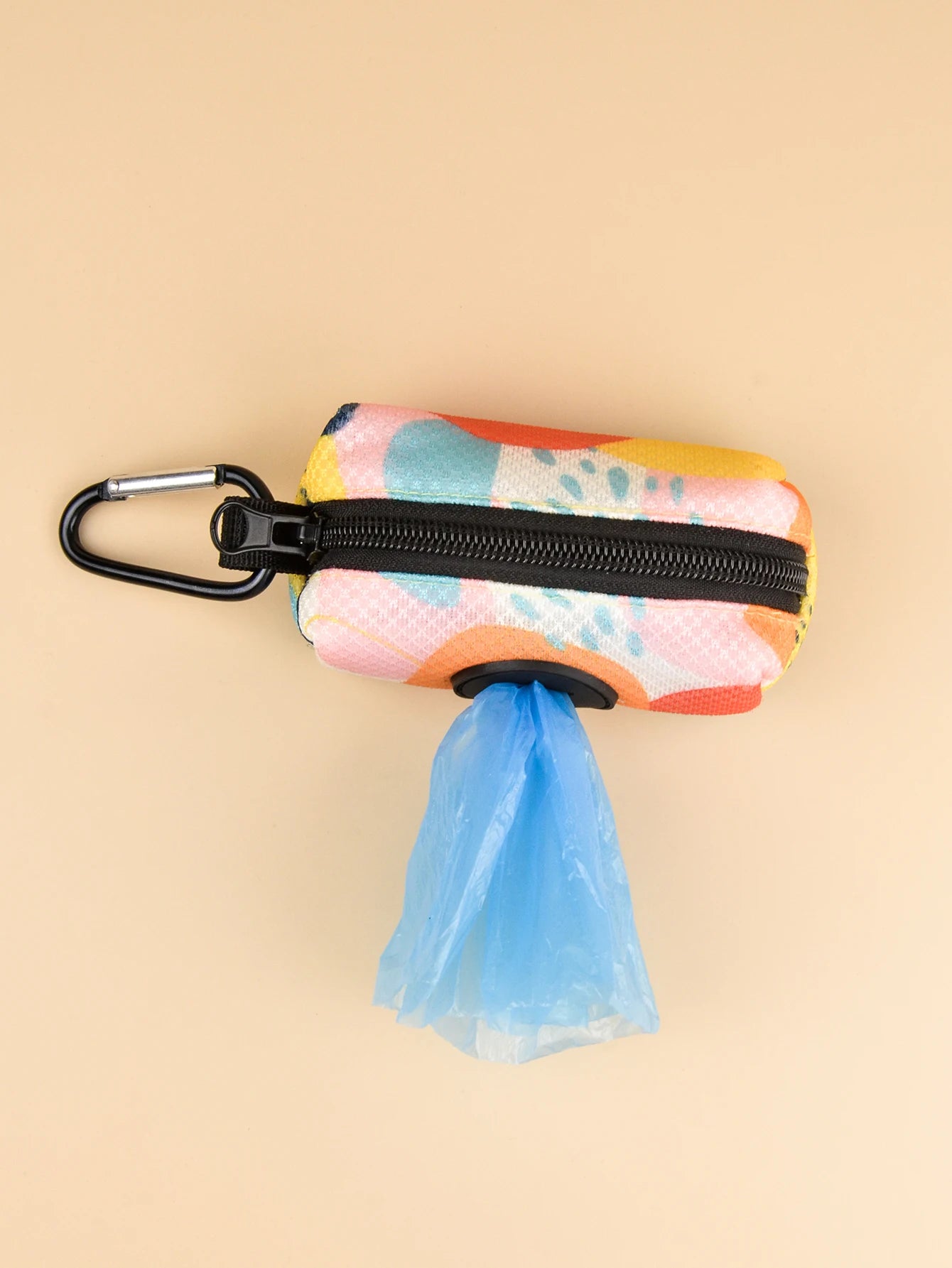 Abstract designer dog poop bag holder dispenser with clip, colorful pet waste bag pouch on beige background