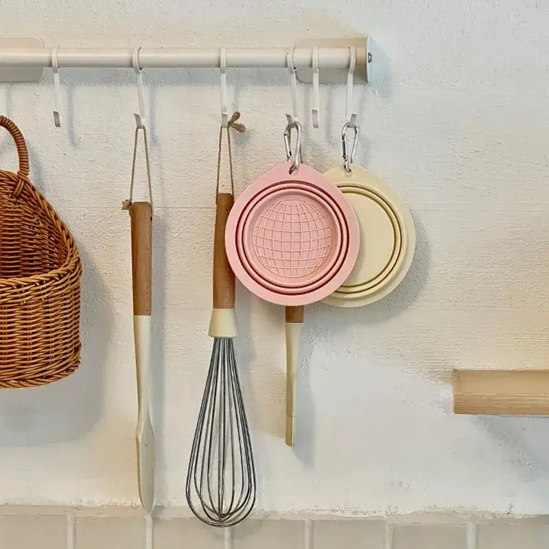 collapsible travel dog bowl, pink and beige silicone folding pet bowl hanging on wall rack for travel feeding