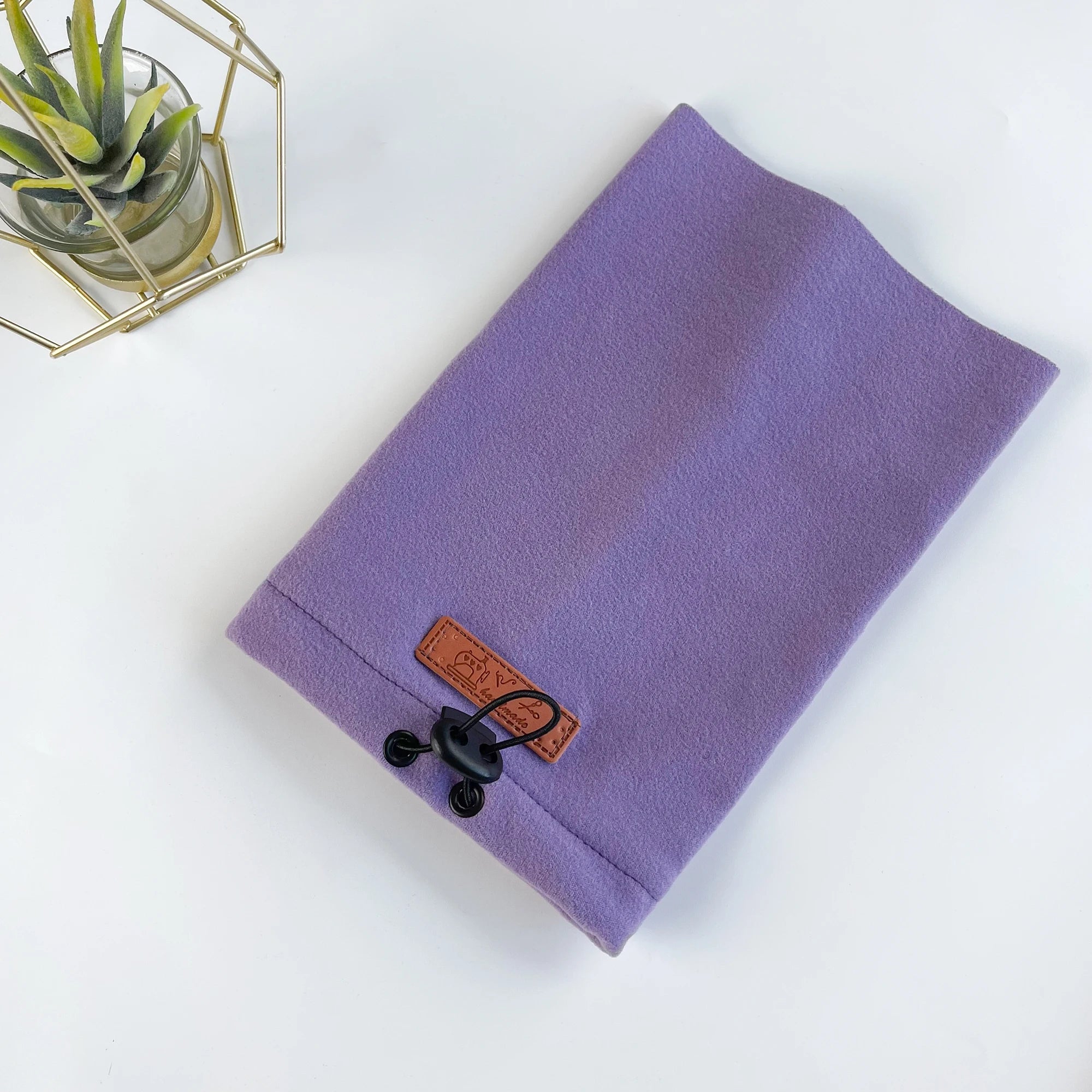 Purple fleece dog snood with adjustable drawstring and brown patch, on white background