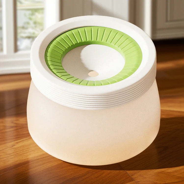 Dog paw cleaning cup with green silicone bristles on hardwood floor