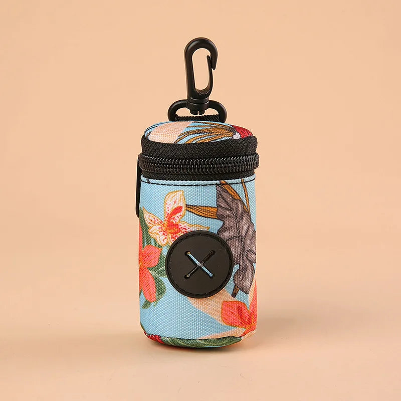 Floral print dog waste bag dispenser with zipper and clip attachment on beige background