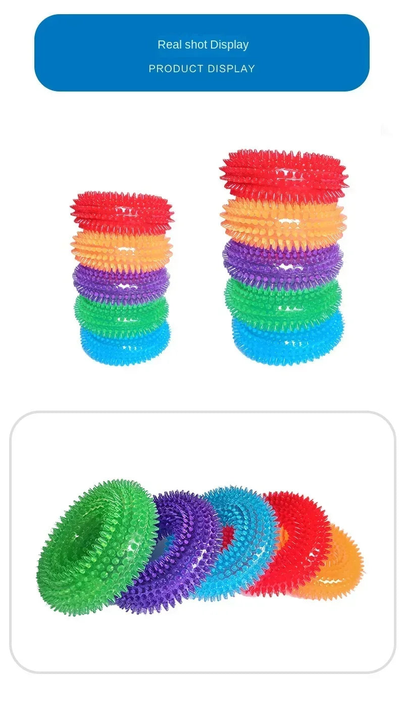 Colorful spiky rubber dog chew ring toys in red, orange, purple, green, and blue.