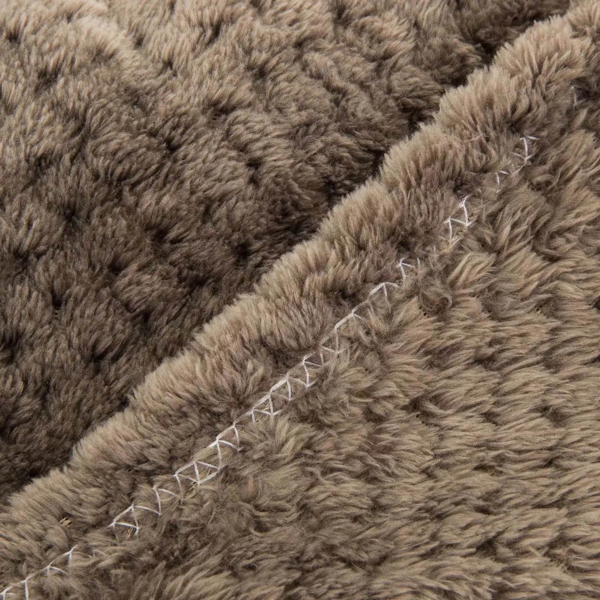 Soft pet blanket close-up of plush brown fur texture with stitched seam for dogs and cats