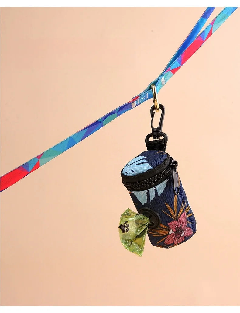 Floral dog waste bag dispenser attached to colorful leash with green bag visible