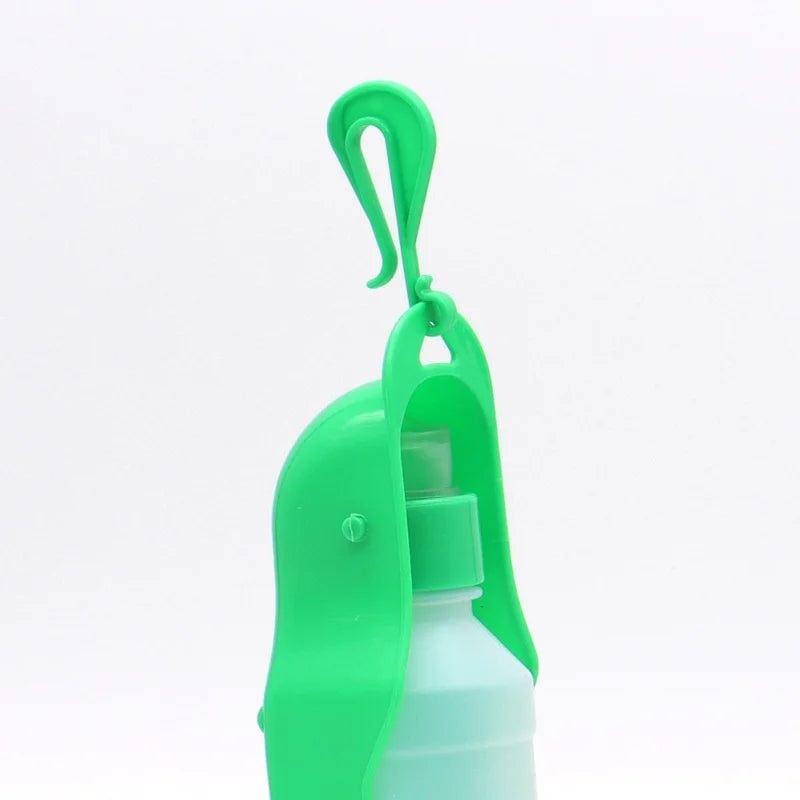 Green portable dog water bottle with clip-on cover for travel, outdoor pet drinking and feeding for dogs and cats