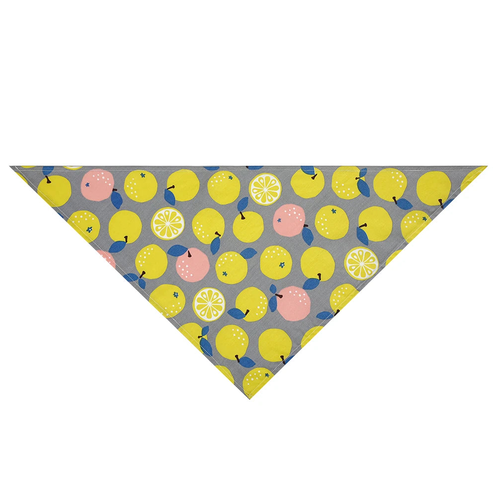 Dog bandana with yellow lemon and pink fruit print on gray background, triangle shape