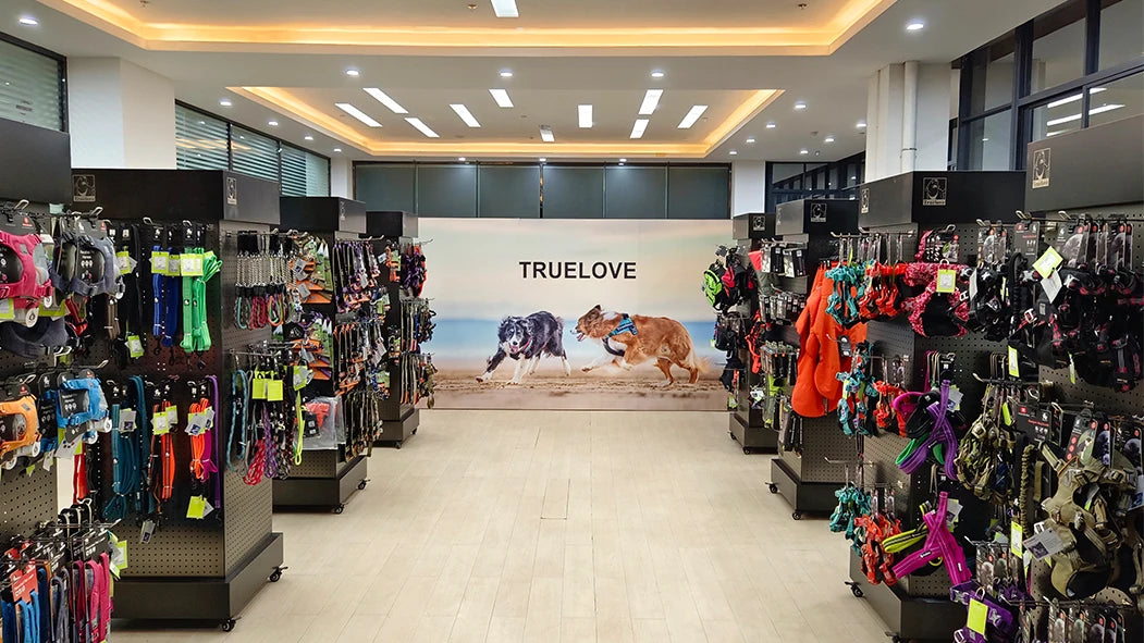 TRUELOVE pet store interior with dog collars and harness displays for dog poop bag holder with carabiner shopping