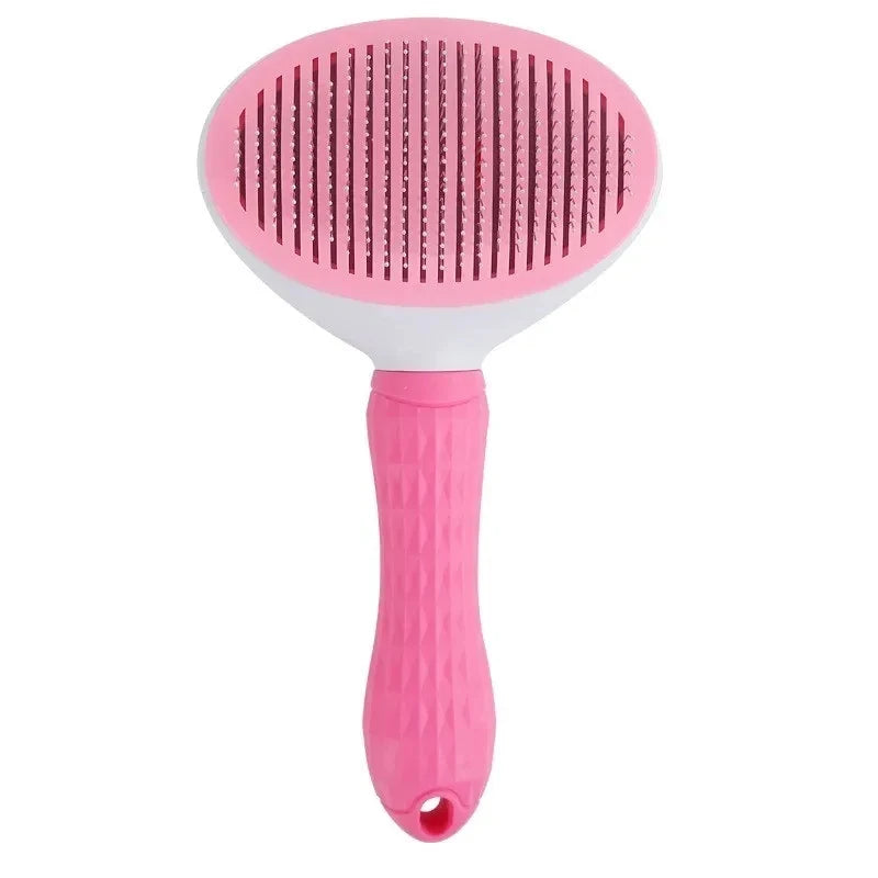 Pink dog grooming brush with textured handle and fine metal bristles on white background