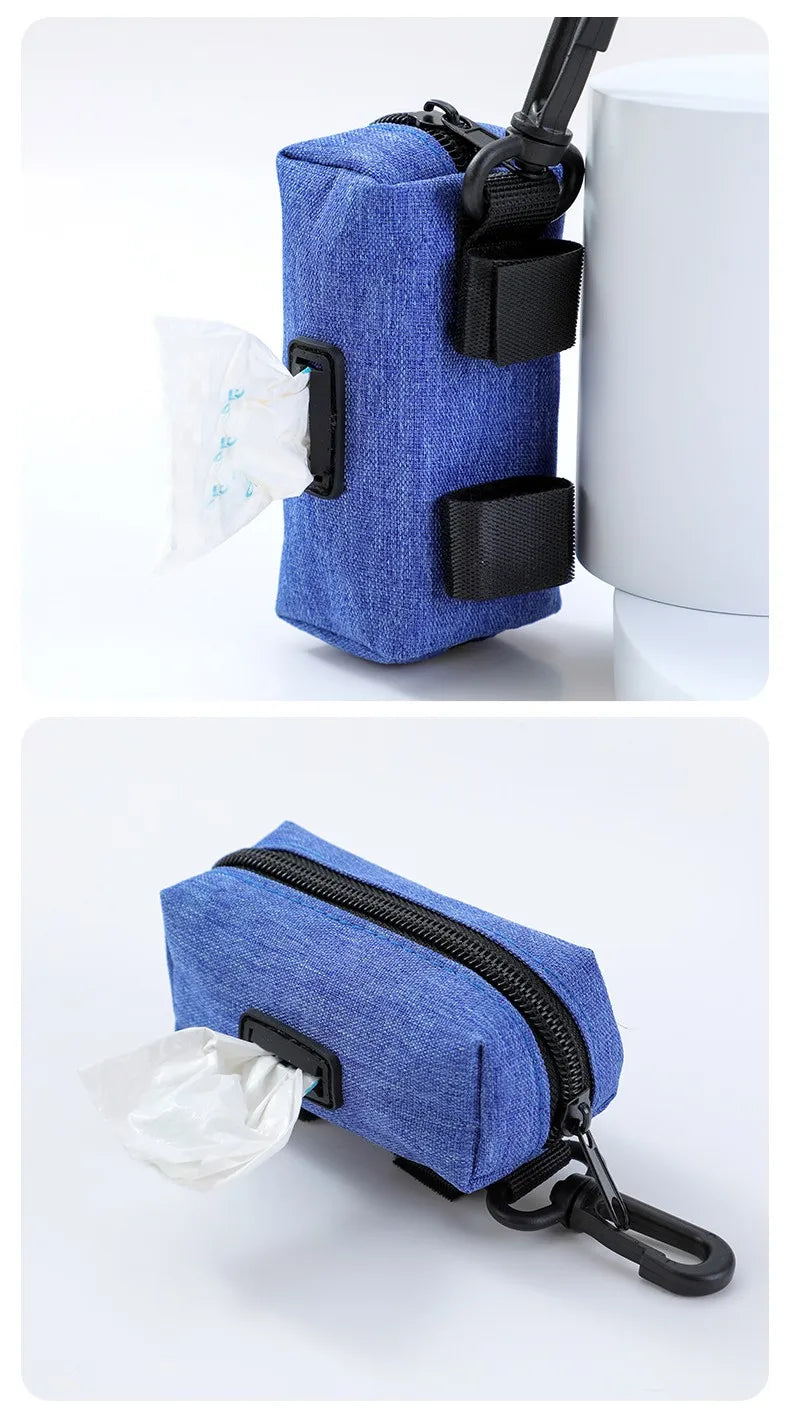 Blue fabric dog poop bag dispenser with zipper, clip, and hook for leash attachment.