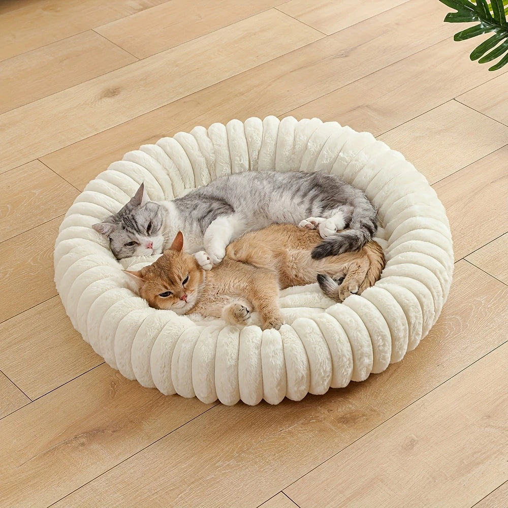 plush donut cat bed with two cats sleeping in a soft round pet nest on a wooden floor