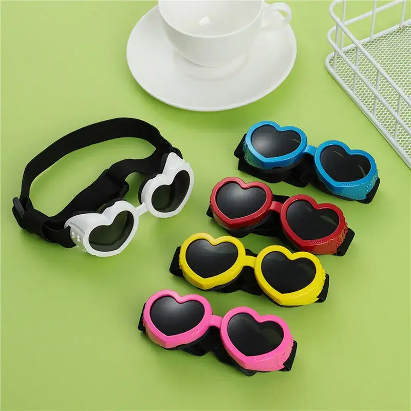 Heart-shaped dog sunglasses with adjustable strap for small pets, UV protection goggles in multiple colors