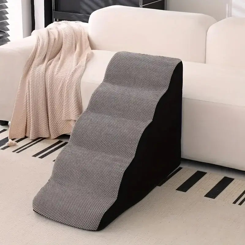 memory foam dog stairs for small pets positioned next to a sofa in a cozy living room setting
