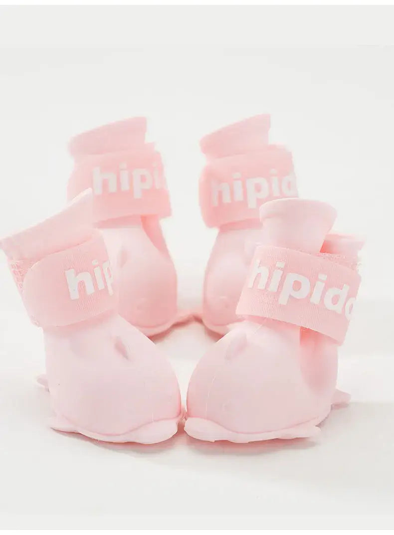 4 pink waterproof dog boots with velcro straps for small and medium pets, ideal for outdoor use and protection.