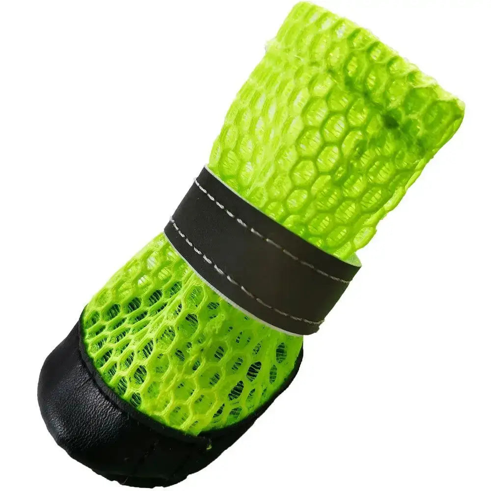 Winter dog boots for small dogs in bright green color, featuring a durable black rubber sole and protective netting.