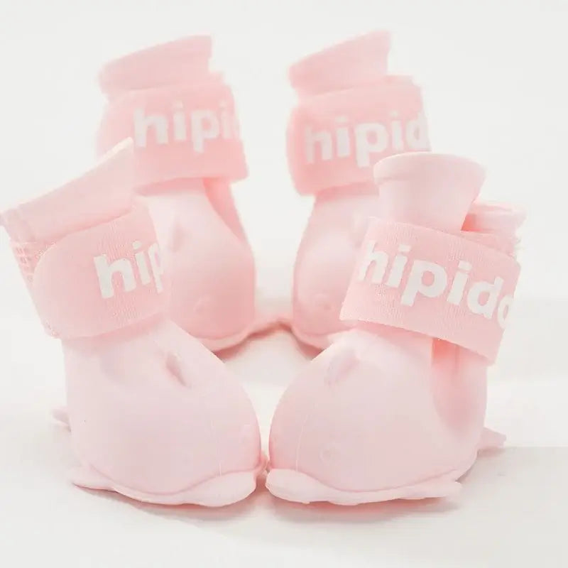 4Pcs waterproof dog boots in pink color for small and medium dogs, featuring anti-slip design for outdoor use.