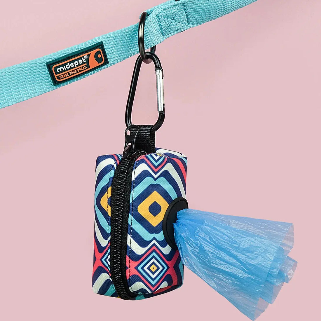 cute dog poop bag holder with colorful geometric design clipped to a turquoise dog leash, featuring bag dispenser opening
