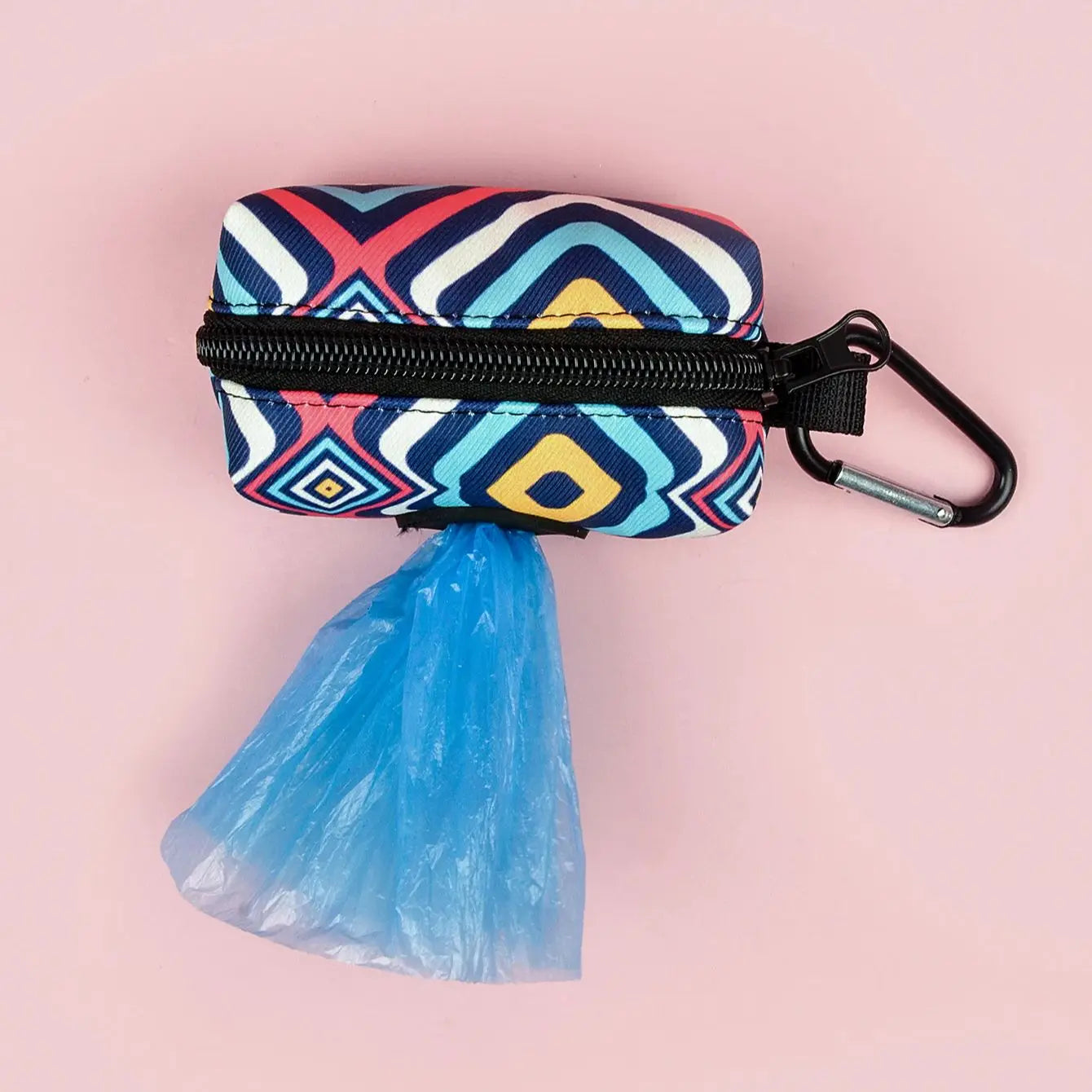 cute dog poop bag holder with geometric print, zipper closure, carabiner clip, and blue waste bag on pink background