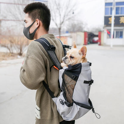 Man carrying a small dog in a breathable dog backpack carrier for outdoor travel, walking, and pet transport