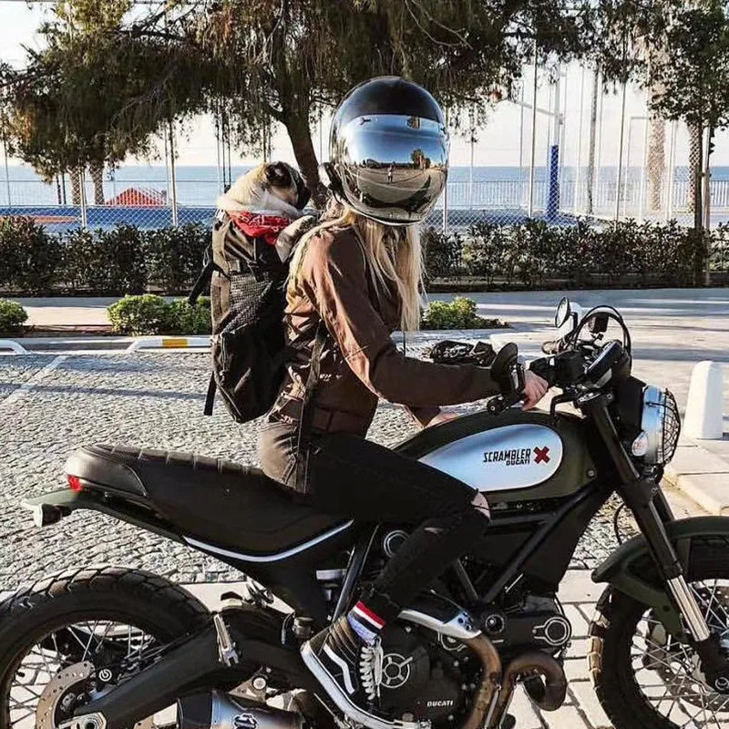 Woman riding motorcycle with a breathable dog backpack carrier for small dogs, outdoor travel pet carrier