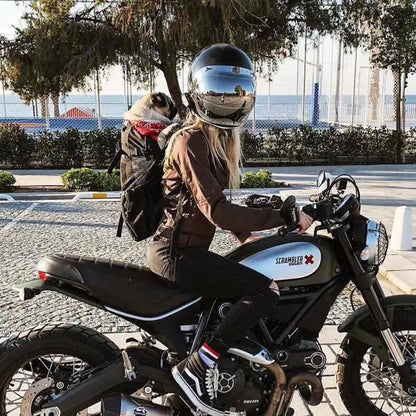 Woman riding motorcycle with a breathable dog backpack carrier for small dogs, outdoor travel pet carrier