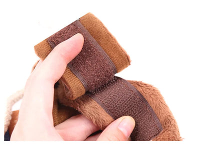 Hand holding brown dog toy with soft fleece fabric and secure velcro strap