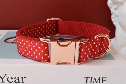 adjustable red bowtie dog collar with red polka dot webbing, rose gold buckle, and quick-release clasp for small dogs and cats