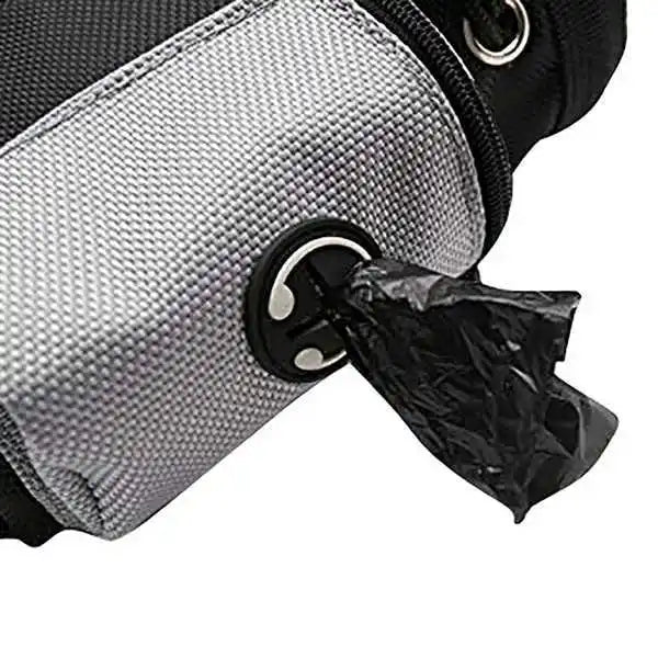 Close up of a gray dog waste bag dispenser pouch with a black poop bag being pulled out