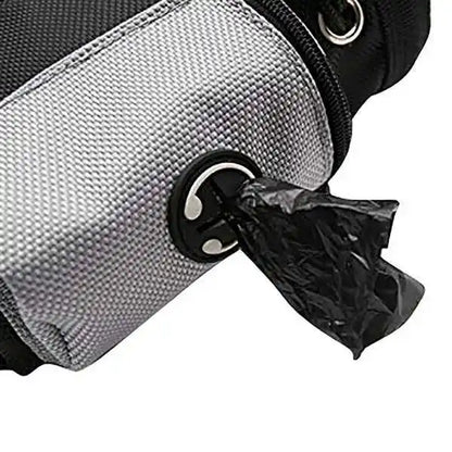 Close up of a gray dog waste bag dispenser pouch with a black poop bag being pulled out