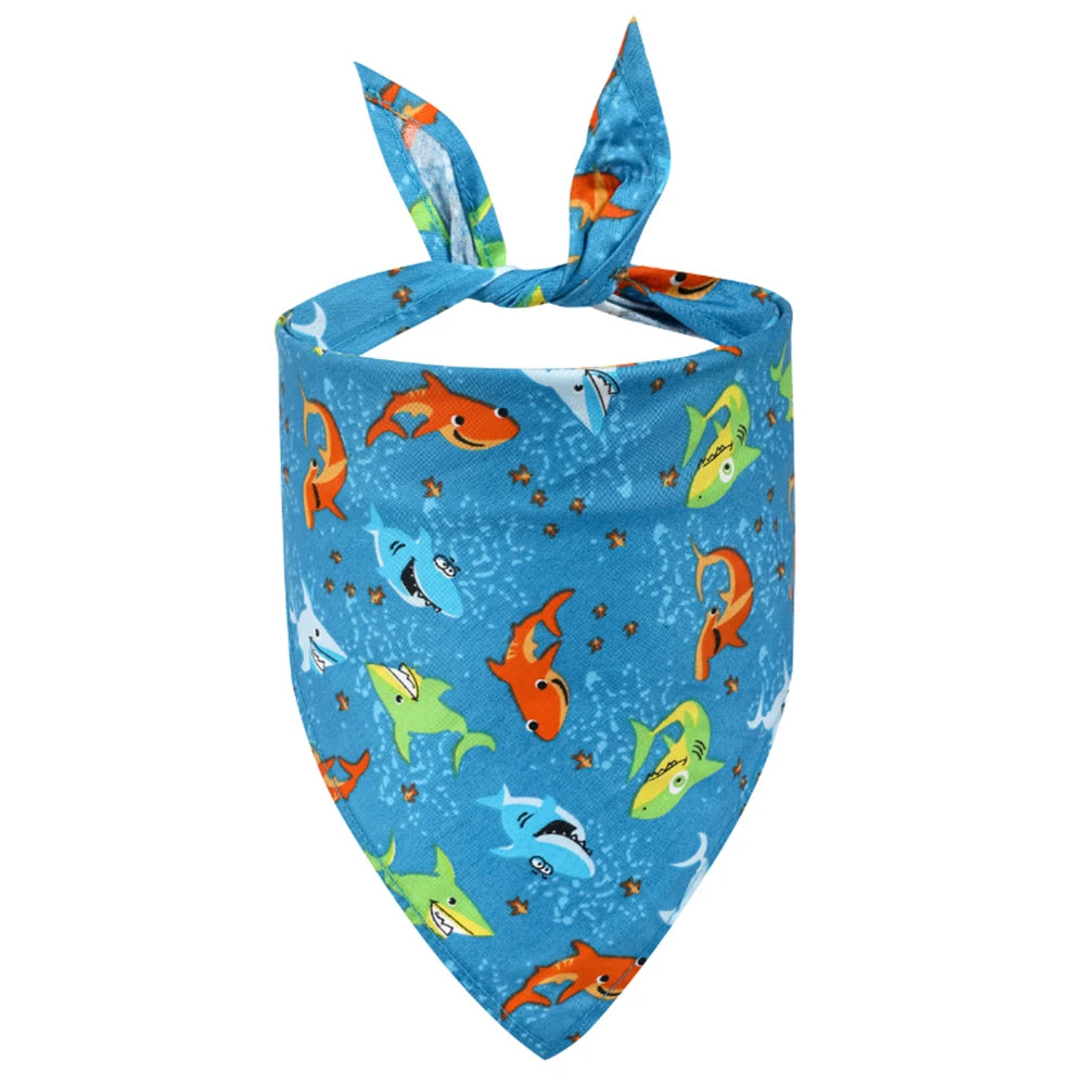 Blue dog bandana with colorful cartoon shark print and tie-up design, pet accessory