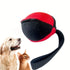 Red and black interactive dog toy ball with handle next to a dog and a cat on white background