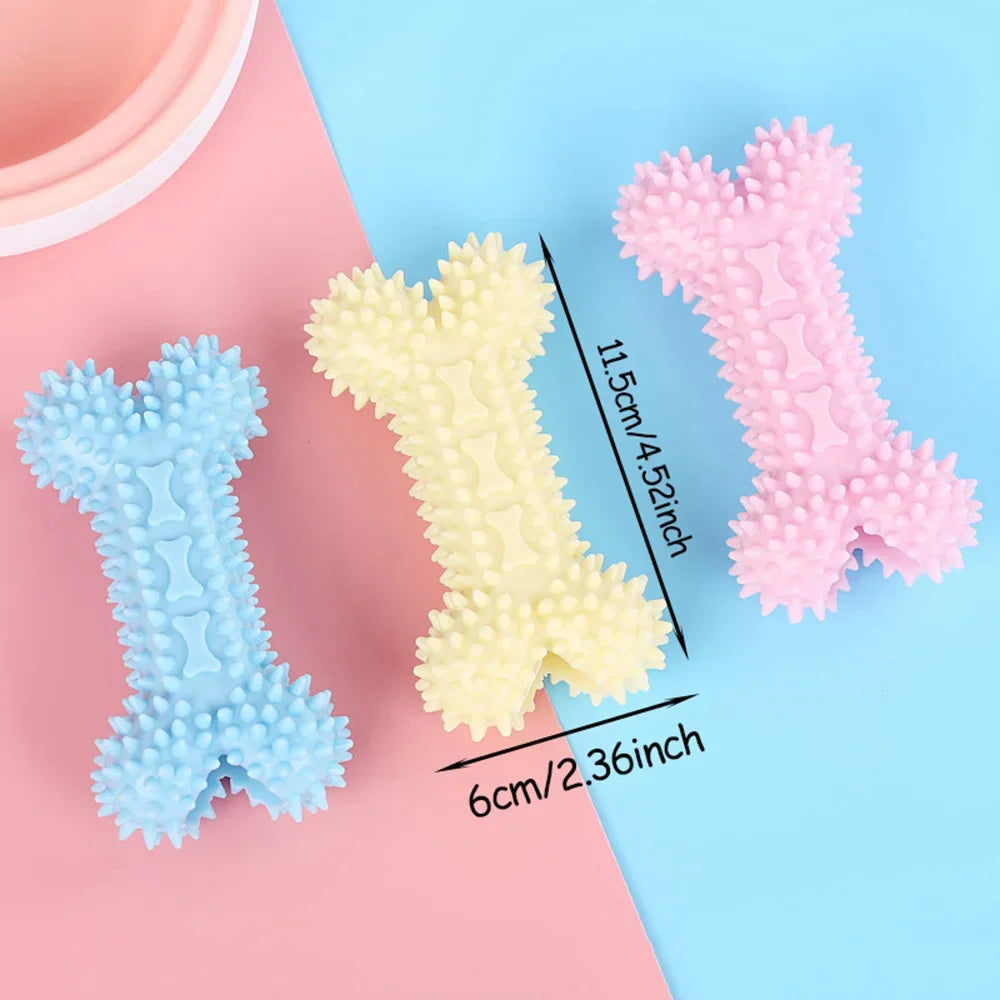 Three spiky rubber bone dog chew toys in blue, yellow, and pink on pastel background, size 11.5cm x 6cm