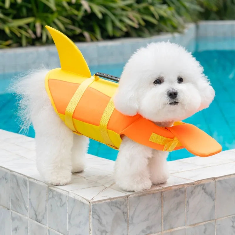 Dog life jacket for small dogs, orange and yellow adjustable swimming safety vest with tail near pool