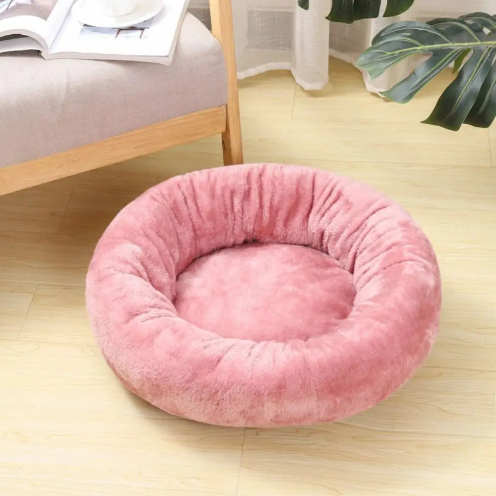 Pink donut dog bed with soft plush cushioning for dogs and cats, cozy round pet bed for restful sleep