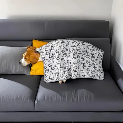 Soft Flannel Pet Blanket for Dogs and Cats on a couch with a sleeping beagle under the paw print design.
