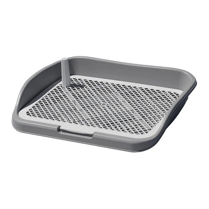 Gray plastic dog potty tray with raised back and removable mesh grid for indoor training