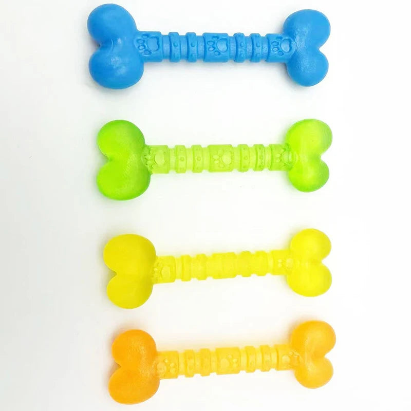 Four colorful bone-shaped dog chew toys in blue, green, yellow, and orange on white background