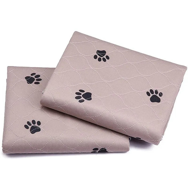 Quilted beige dog blanket with black paw prints, folded, pet bedding accessory