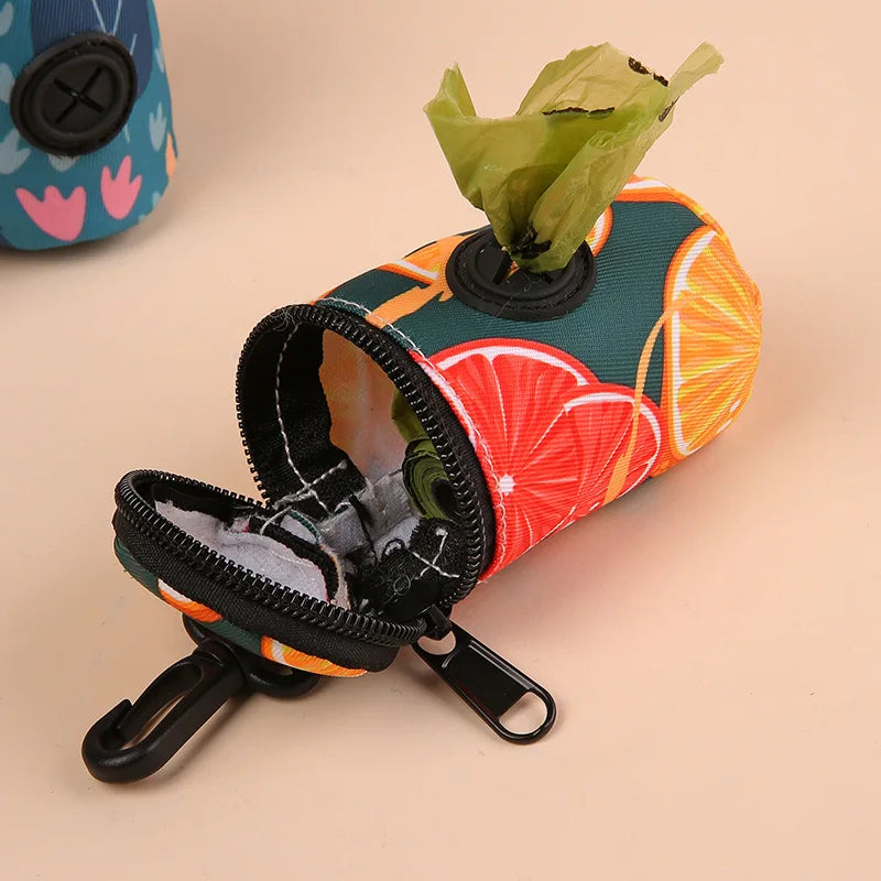 Citrus print dog poop bag holder with zipper and attached waste bag, beige background.