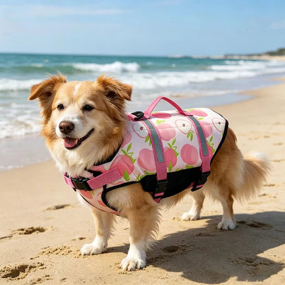 Reflective adjustable dog life jacket for large dogs, pink floral pet swim vest with buoyancy and safety straps on a beach