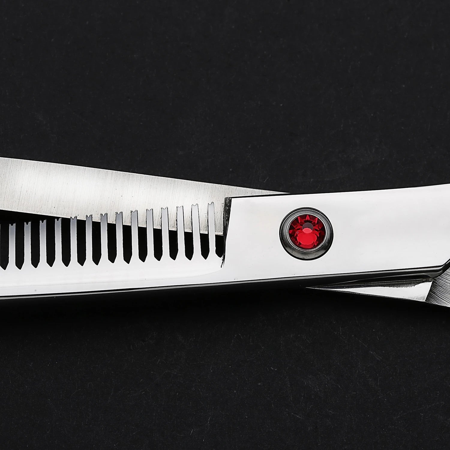 Stainless steel dog grooming thinning shears with red pivot screw on black background
