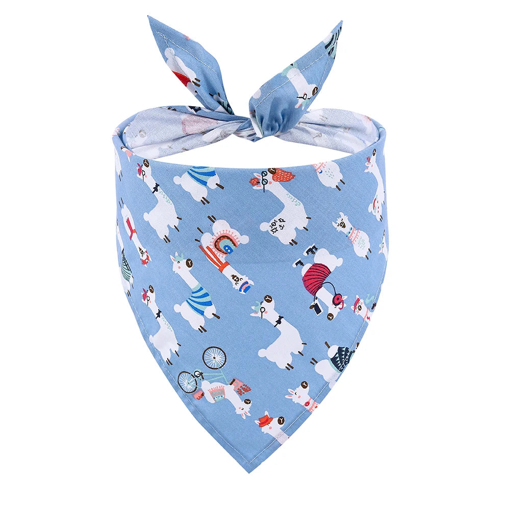 Blue dog bandana with colorful cartoon llama pattern, folded and tied, pet accessory