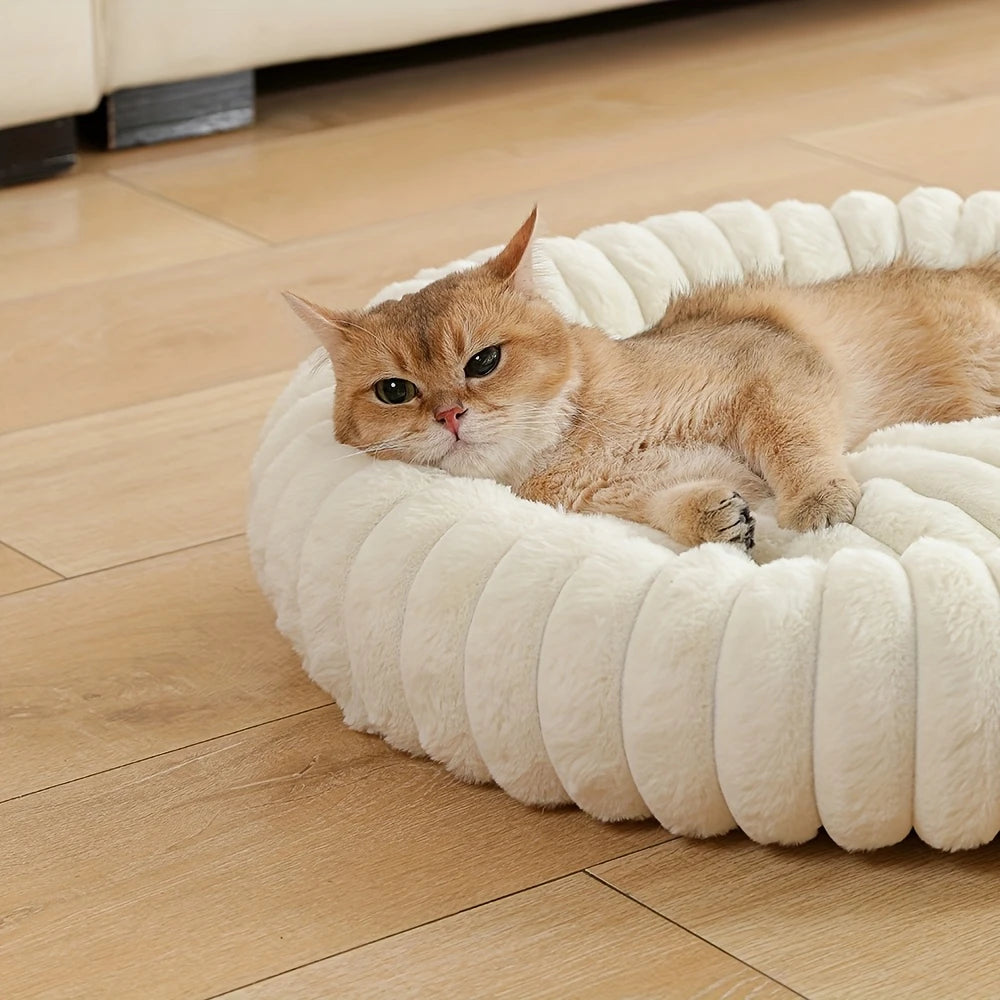 plush donut cat bed with a cozy cat resting on a soft round cream pet nest on a wooden floor