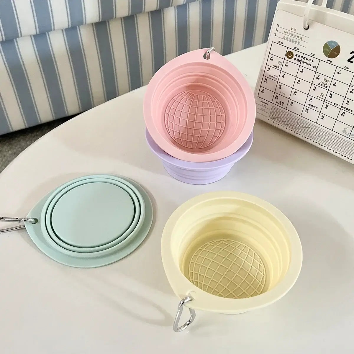 Collapsible travel dog bowl in pastel silicone for portable pet feeding, foldable water and food bowl for dogs and cats