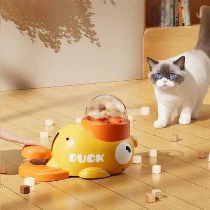 automatic cat treat dispenser interactive duck-shaped feeder with cat and scattered treats on wooden floor