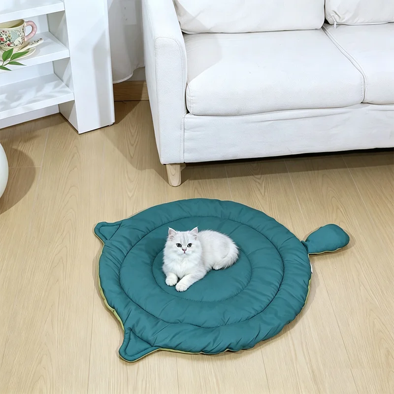 washable cat dog bed mat in teal cat-face design with white cat resting on soft cushioned pet bed