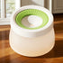 Dog paw cleaning cup with green silicone bristles on hardwood floor