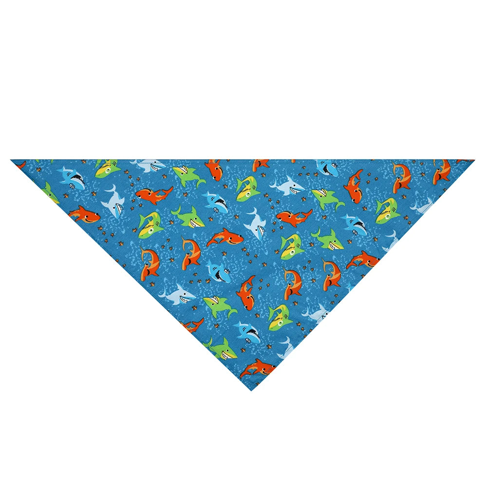 Blue dog bandana with colorful shark pattern, fun pet accessory for dogs.