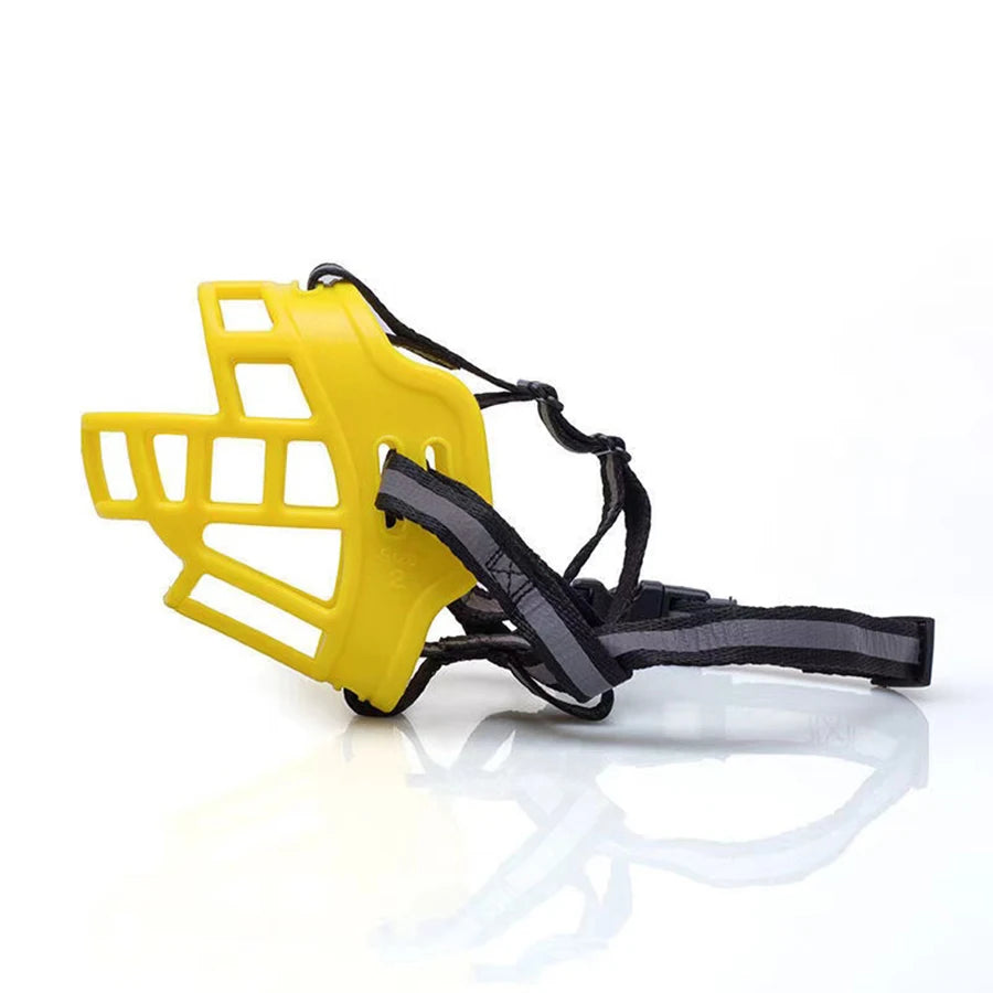 Yellow basket dog muzzle with adjustable black straps on white background